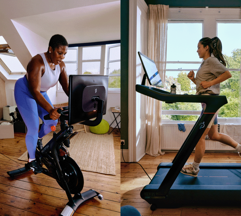 Two women using Peloton equipment in a bright home setting. One woman energetically cycles on a Peloton Bike+ and the second woman runs on a Peloton Tread.