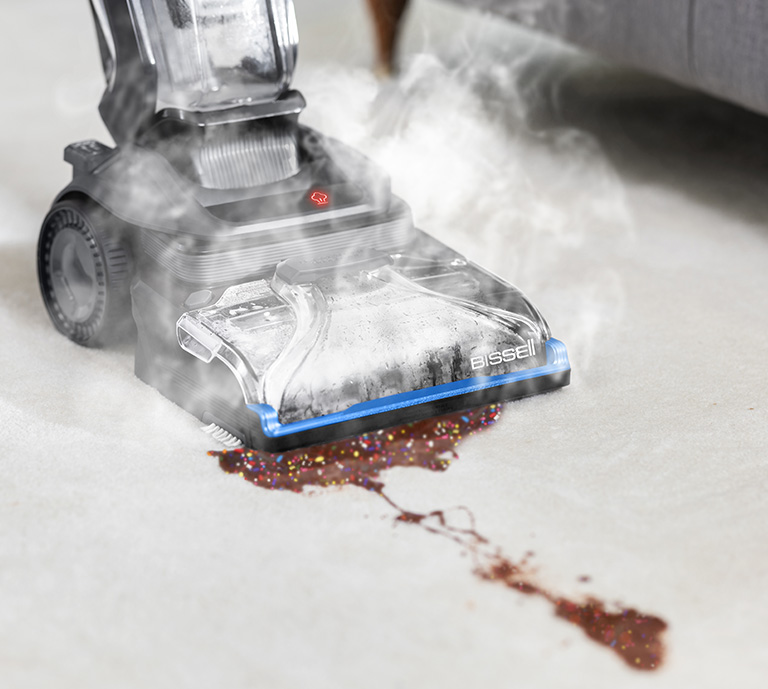 BISSELL SpotClean HydroSteam in action cleaning up red wine from a cream sofa