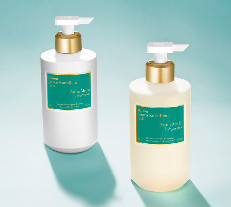 Maison Francis Kurkdjian Aqua Media Cologne Forte cleansing gel & lotion bottles on light blue background